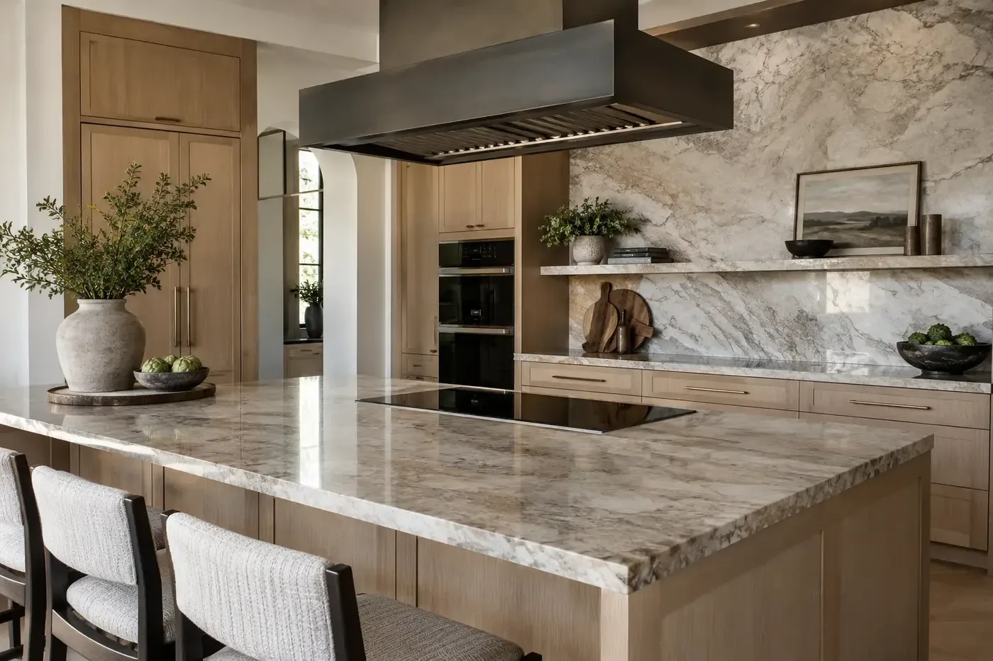 Illustrative luxury custom-home kitchen with a flush induction cooktop and substantial vent hood
