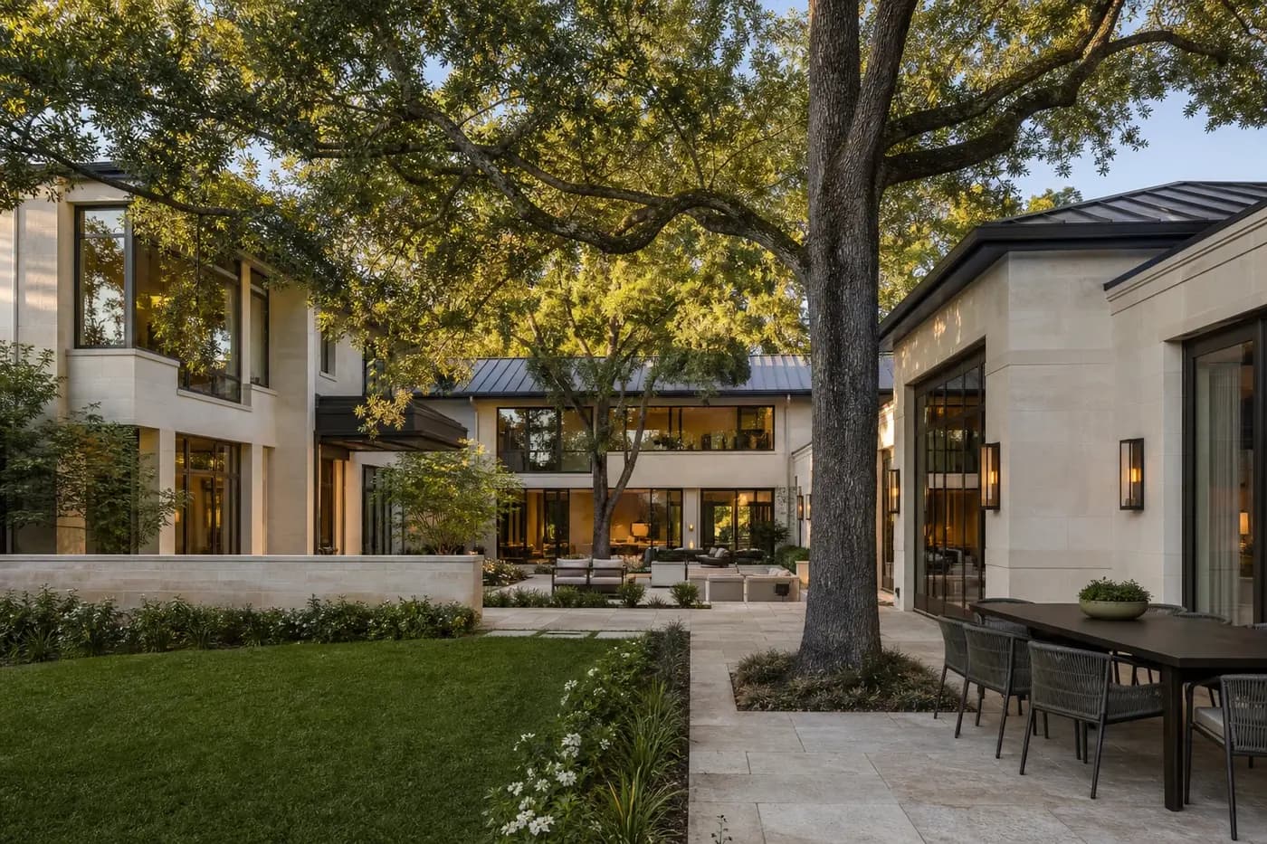 Private luxury home courtyard organized around retained mature oak trees