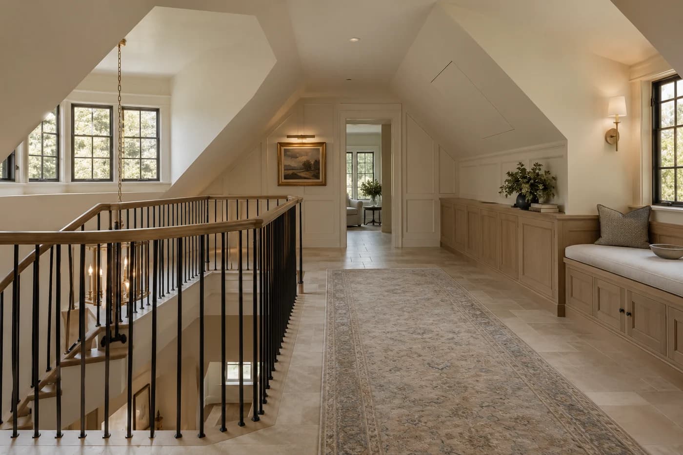 Illustrative luxury custom-home upper landing with coordinated sloped ceilings and discreet attic access