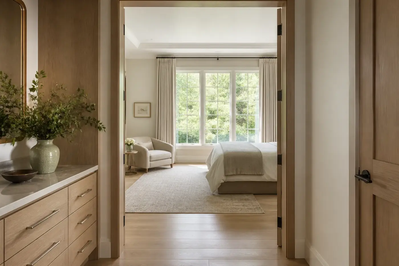 Main-level suite in a new Charlotte custom home with a wide doorway, flush floor transition, and generous circulation
