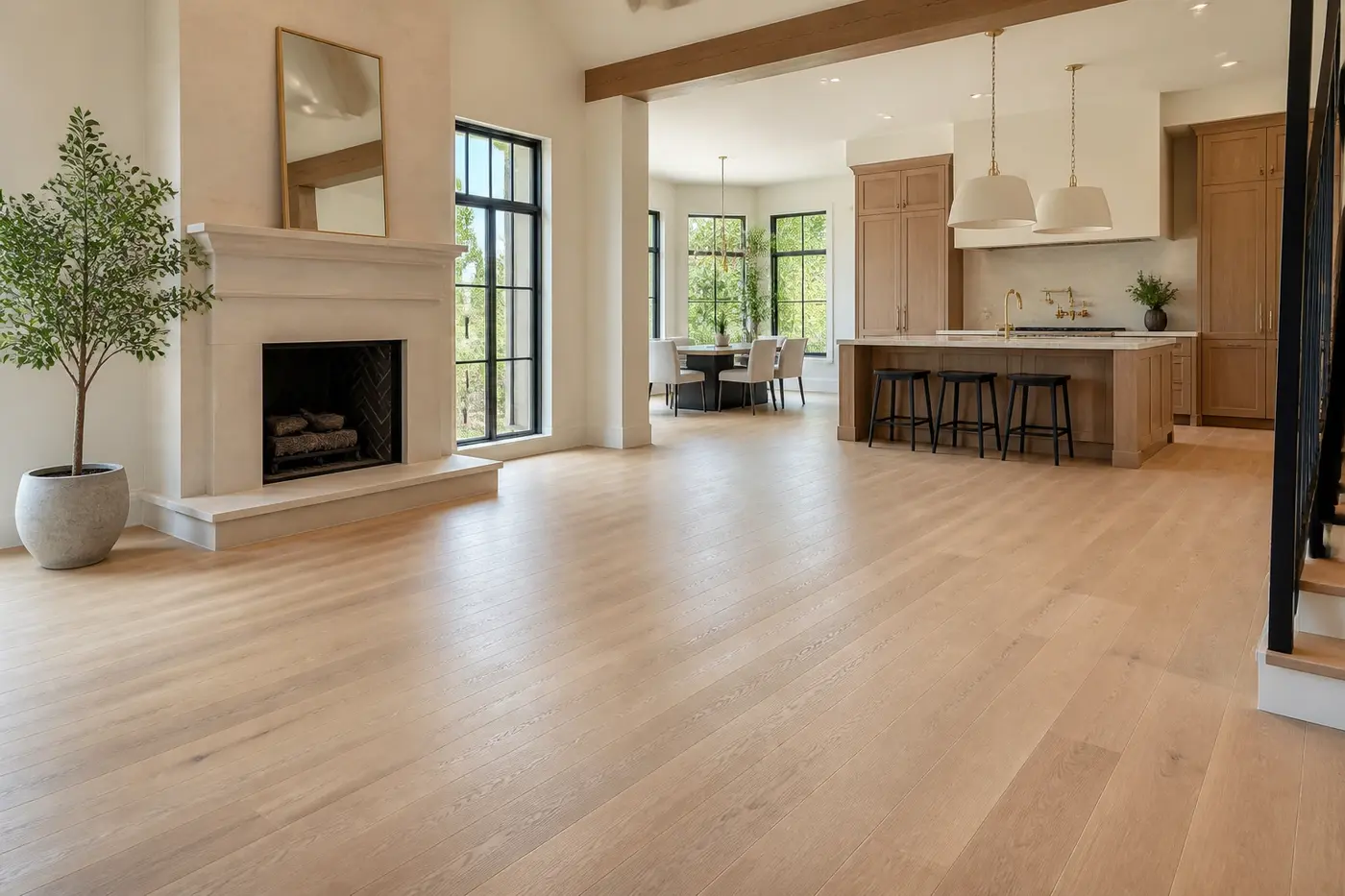 New Charlotte luxury custom-home great room and kitchen with continuous wide-plank white oak flooring, limestone fireplace, and white oak cabinetry