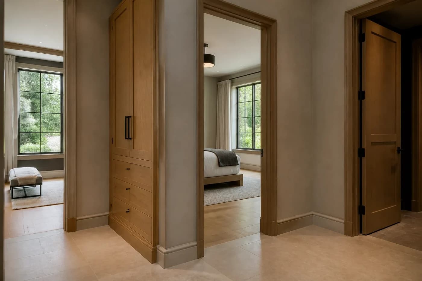 New Charlotte custom-home guest wing with clear bedroom entries, white oak linen storage, and a quiet private hall