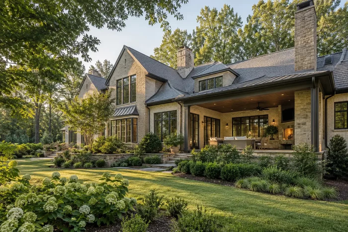 Illustrative luxury Charlotte-area custom home coordinated with layered landscaping, preserved trees, and a garden-facing terrace