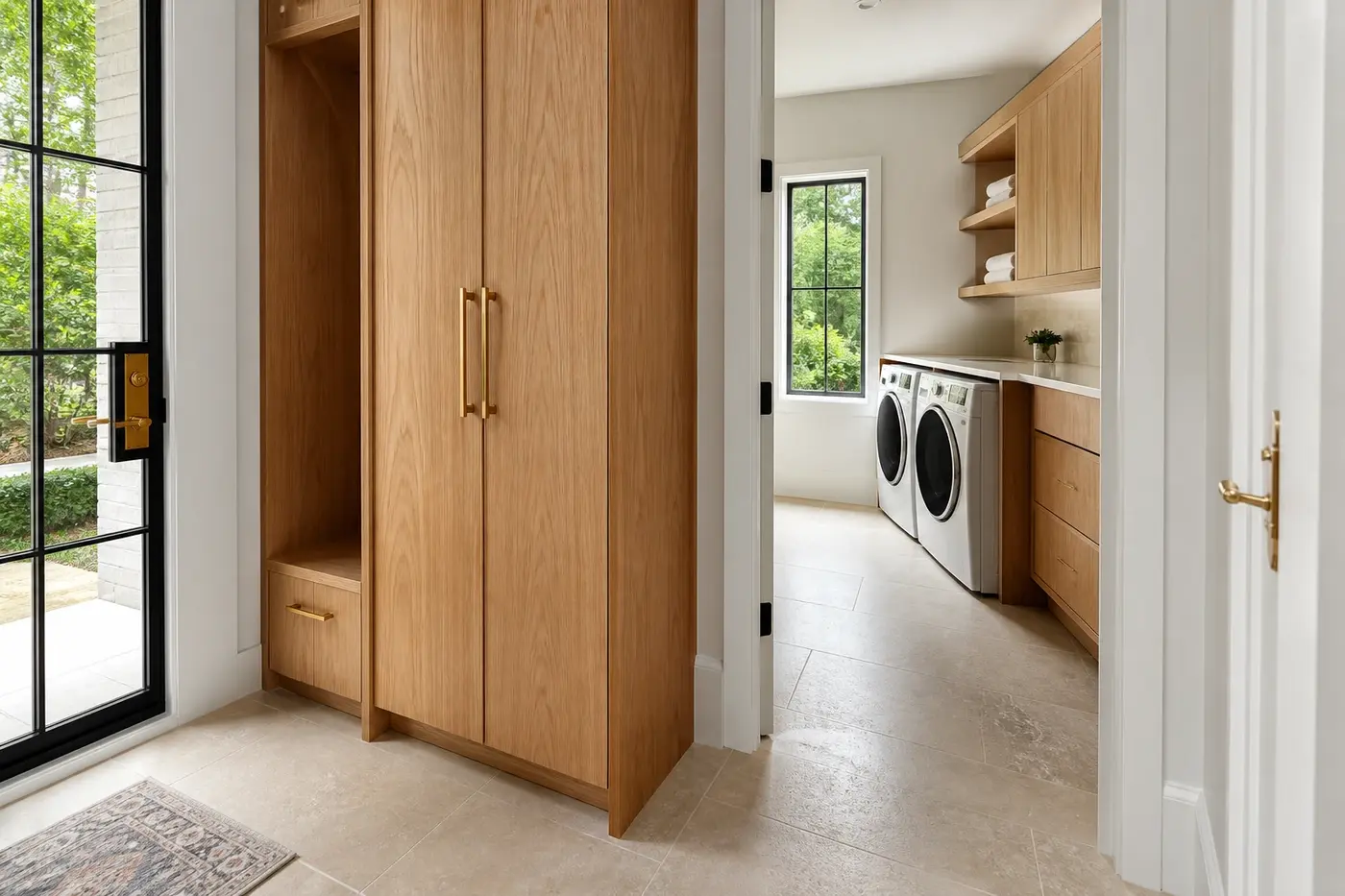 Everyday entry in a new Charlotte custom home leading past white oak storage to a dedicated laundry room