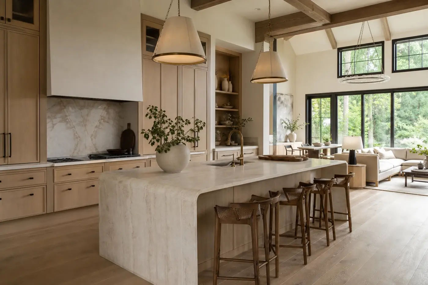 Luxury open-plan kitchen and great room with white oak cabinetry, stone island, and large garden windows