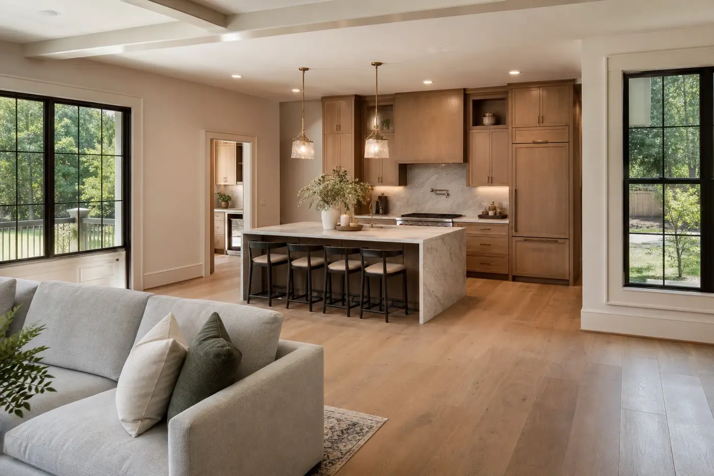 Luxury kitchen viewed from an adjoining great room with clear circulation around a stone island