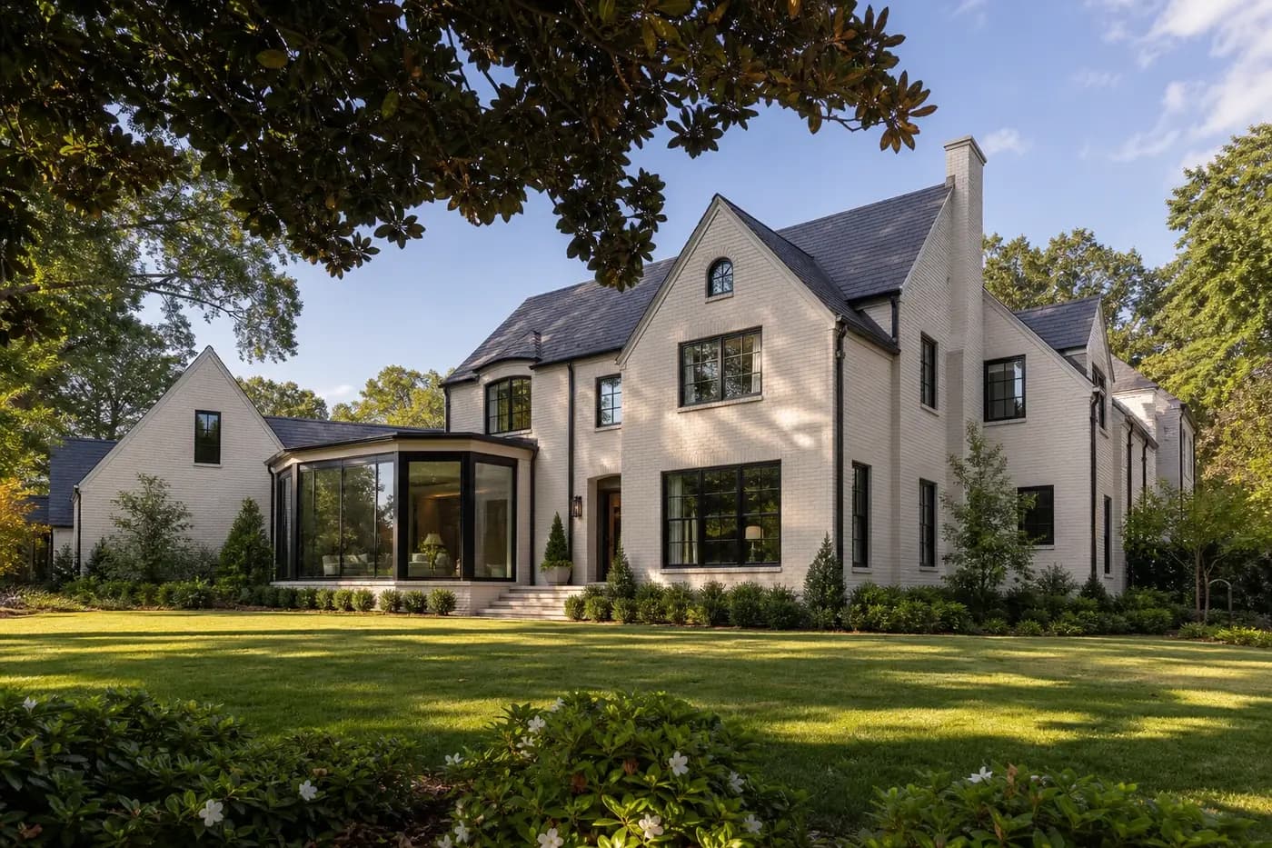 Renovated painted-brick Charlotte estate with preserved traditional proportions and a modern glass garden room