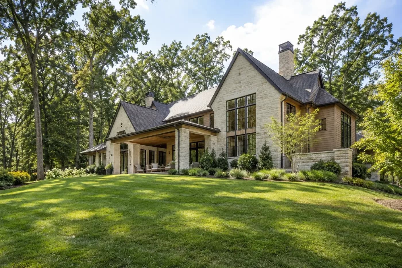 Illustrative luxury custom home on a broad wooded Charlotte-area lot with open land for site planning